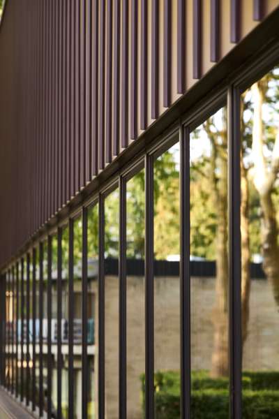 New sports hall in the “forest” wrapped in acorn-brown steel profiles, Risskov Efterskole, Tretommervej 31A, 8240 Risskov, Denmark